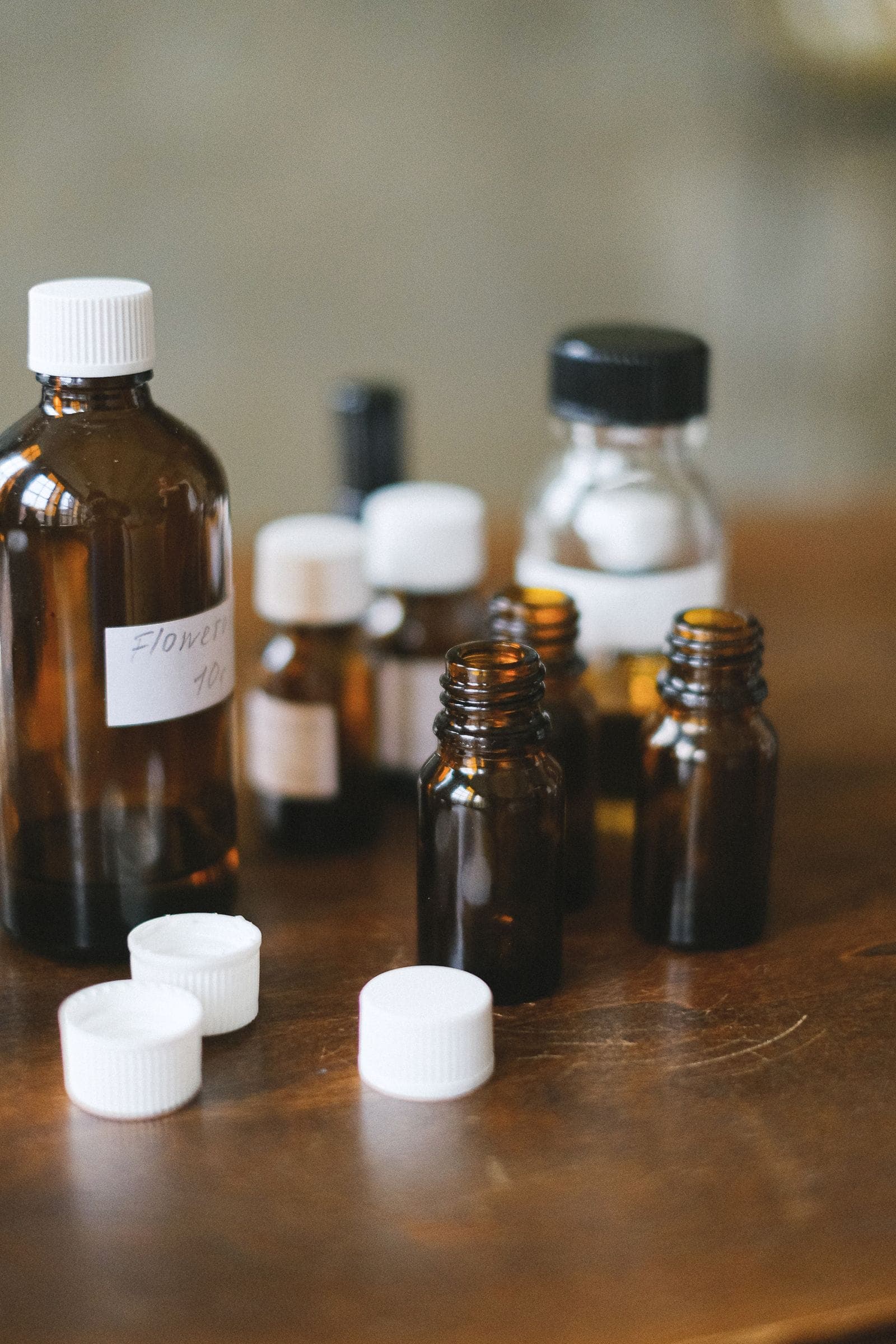 Amber glass remedy bottles on a wooden table